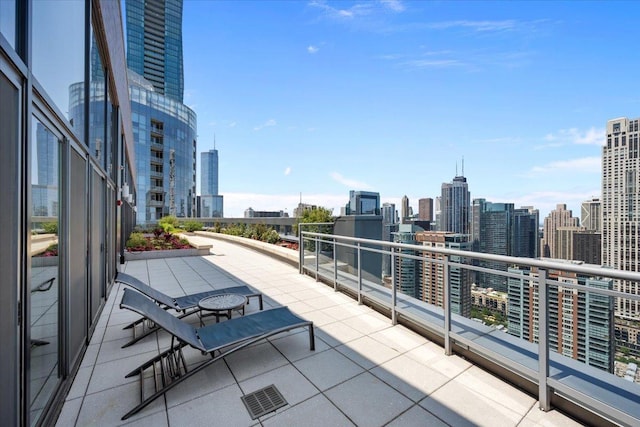 view of patio with a city view and a balcony