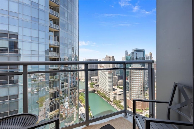 balcony with a view of city and a water view