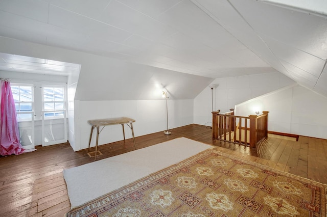 additional living space featuring lofted ceiling and hardwood / wood-style flooring