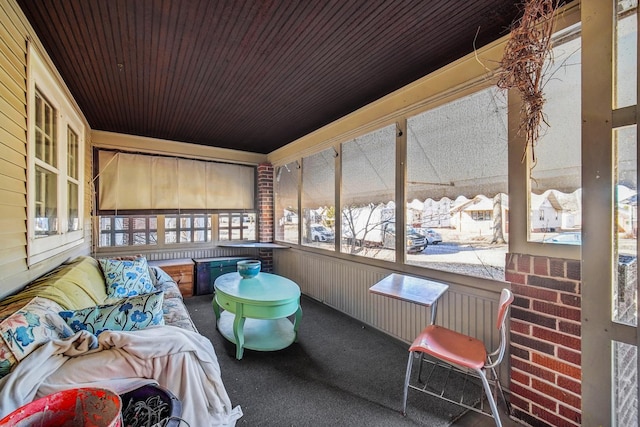 sunroom with wooden ceiling and a hot tub