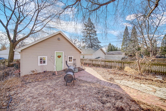 exterior space featuring an outdoor fire pit and fence