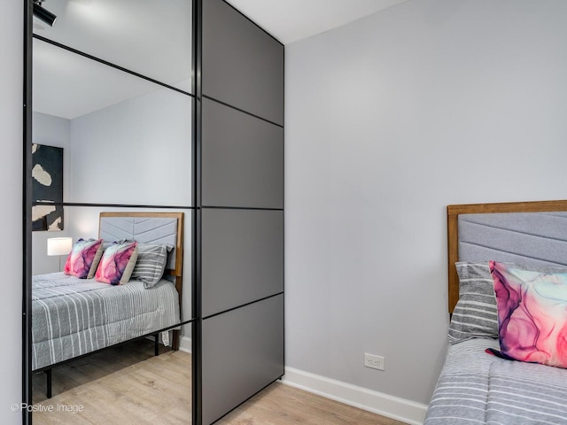 bedroom featuring baseboards and light wood-style floors