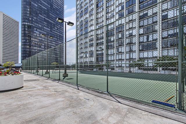 view of tennis court with fence