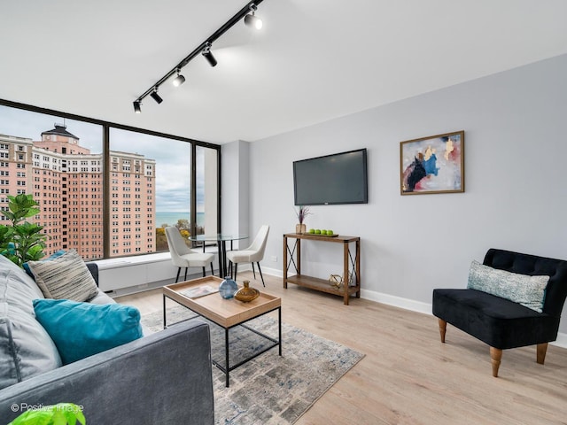 living area featuring baseboards and wood finished floors