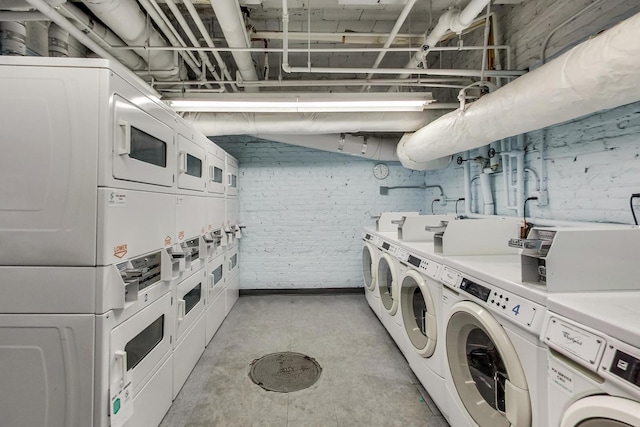 shared laundry room with stacked washer / dryer and washing machine and dryer