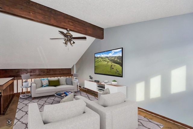 living room featuring baseboards, a textured ceiling, lofted ceiling with beams, and ceiling fan