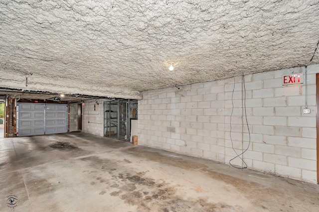 garage with concrete block wall