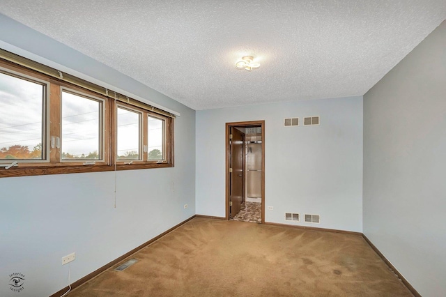 spare room with carpet and visible vents