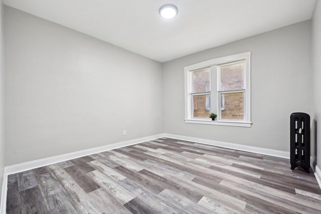 unfurnished room featuring wood finished floors and baseboards