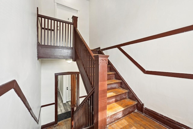 stairs with baseboards and wood finished floors