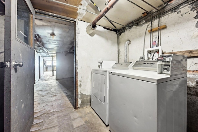 washroom featuring washing machine and clothes dryer and laundry area