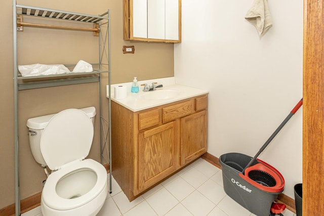 bathroom featuring tile patterned flooring, toilet, vanity, and baseboards