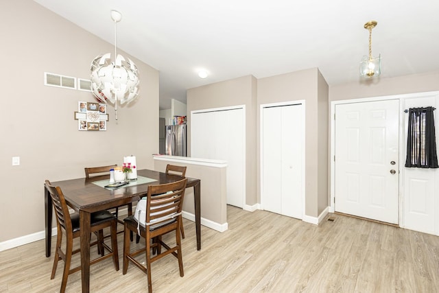 dining space with visible vents, baseboards, and light wood-type flooring