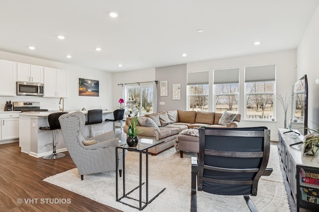 living room with recessed lighting and wood finished floors