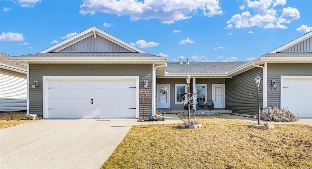 ranch-style home with concrete driveway, an attached garage, and a shingled roof