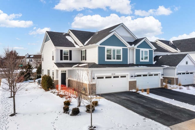 view of front of home with aphalt driveway and an attached garage