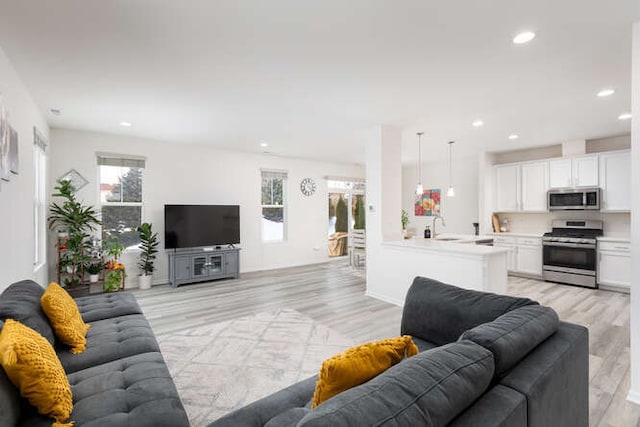 living room featuring recessed lighting and light wood-style floors