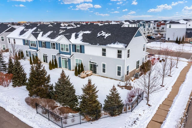 snowy aerial view with a residential view