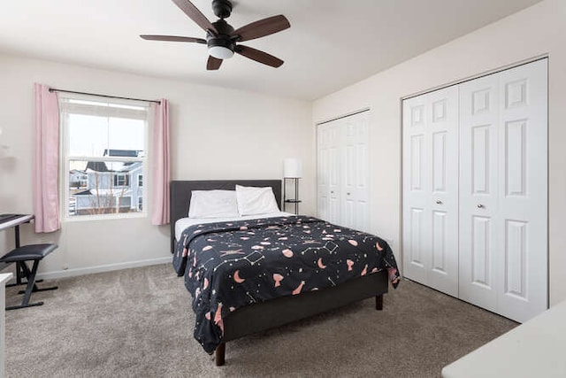 bedroom featuring a ceiling fan, baseboards, two closets, and carpet flooring