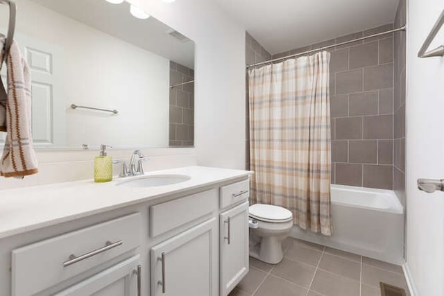 bathroom featuring vanity, visible vents, shower / bath combo with shower curtain, tile patterned floors, and toilet