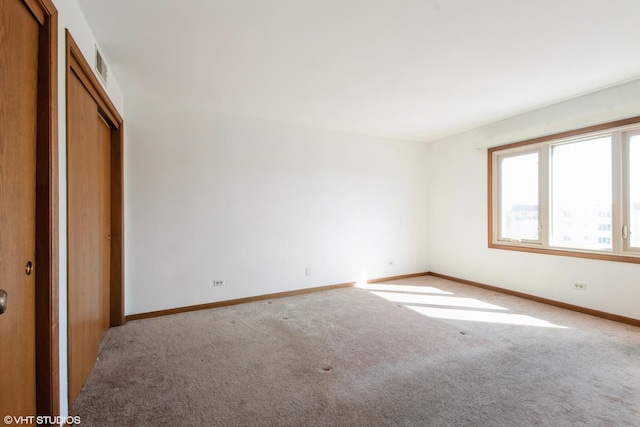unfurnished bedroom with a closet, baseboards, and carpet