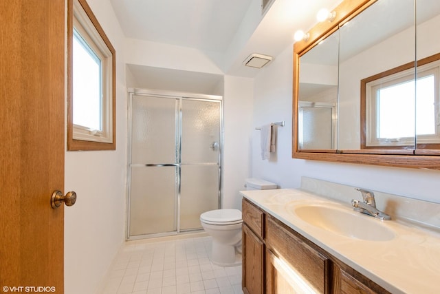 bathroom with tile patterned floors, vanity, toilet, and a shower stall