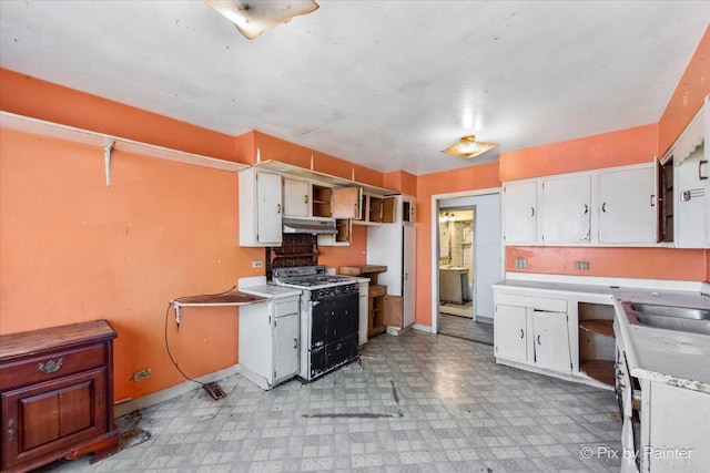 kitchen featuring white cabinetry, gas range, light floors, and a sink