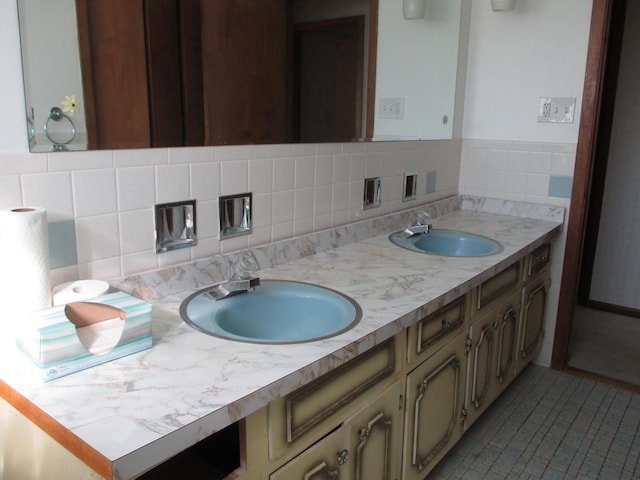 bathroom featuring double vanity, tasteful backsplash, and a sink