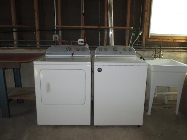 clothes washing area featuring separate washer and dryer and laundry area