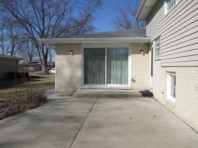 exterior space with a patio and brick siding