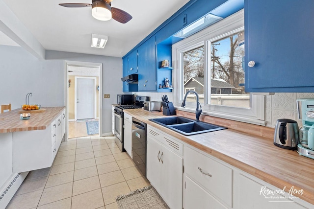 kitchen with stainless steel gas range, a sink, wood counters, dishwasher, and a baseboard heating unit