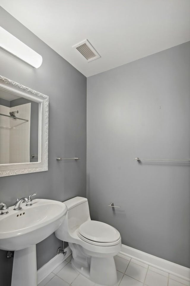 bathroom with tile patterned flooring, visible vents, toilet, and baseboards