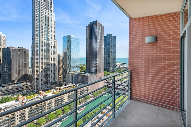 balcony featuring a city view and a water view