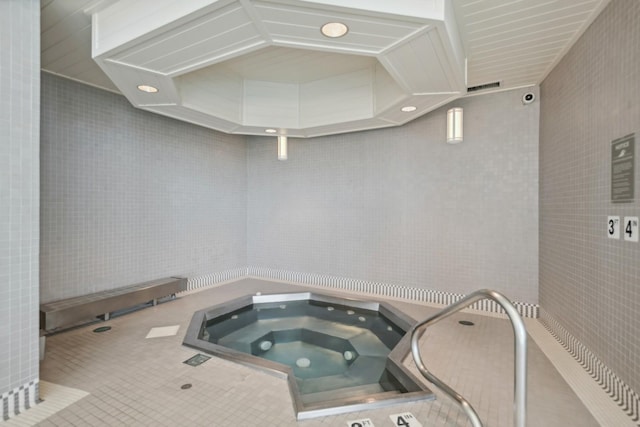 interior space featuring tile patterned flooring and tile walls