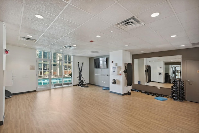 gym with visible vents, baseboards, and wood finished floors