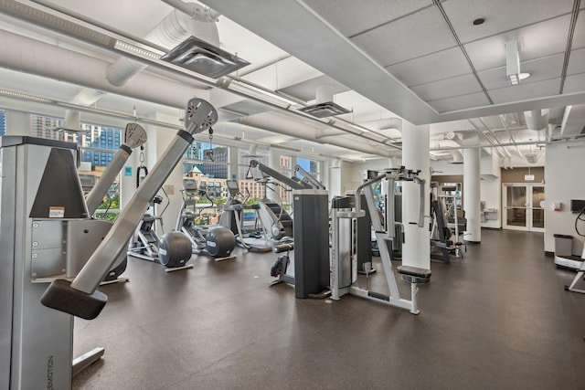 workout area with a paneled ceiling