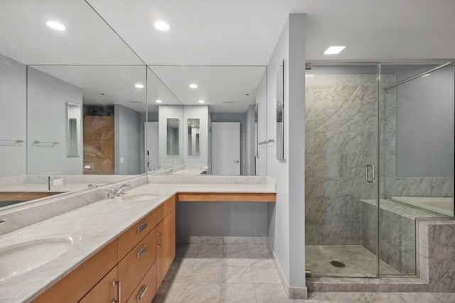 full bath featuring a sink, marble finish floor, a stall shower, and double vanity