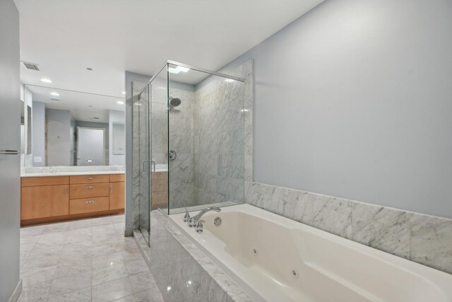 bathroom featuring visible vents, a stall shower, a sink, a jetted tub, and double vanity