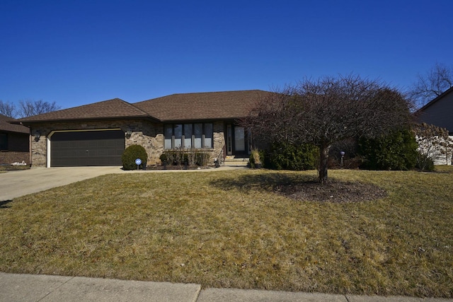 view of front facade with concrete driveway, a garage, a front yard, and roof with shingles