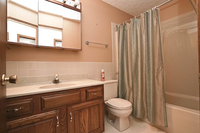 full bathroom with shower / tub combo with curtain, toilet, a textured ceiling, tile walls, and vanity