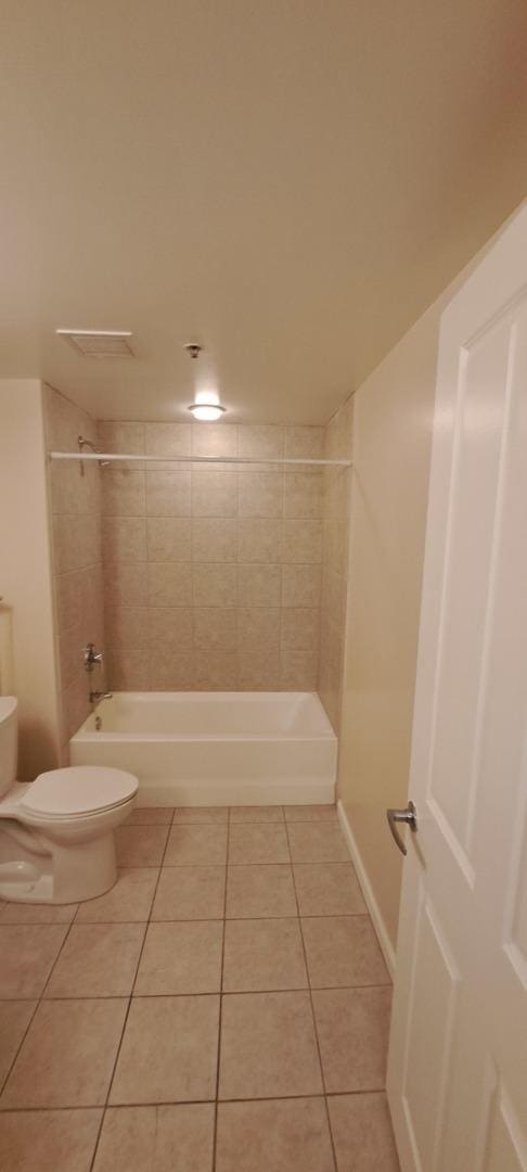 full bathroom with tile patterned floors, toilet, and bathing tub / shower combination