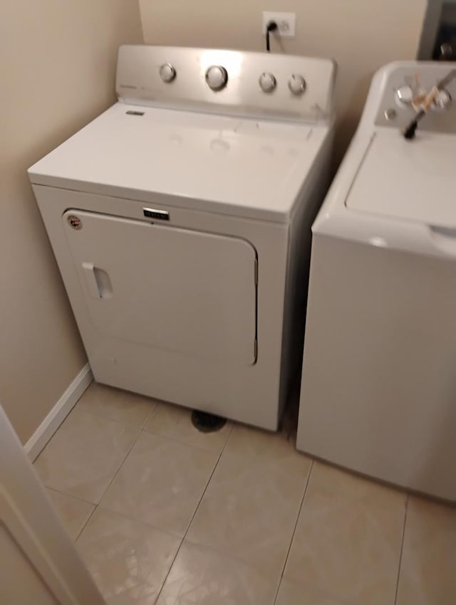 laundry area featuring light tile patterned flooring, laundry area, and separate washer and dryer