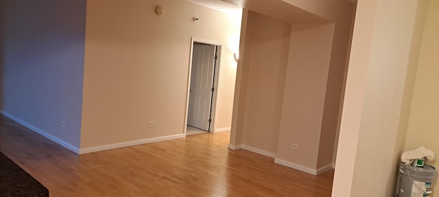 spare room with light wood finished floors and baseboards