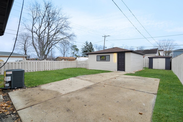 view of patio / terrace featuring an outdoor structure, central AC unit, and a fenced backyard