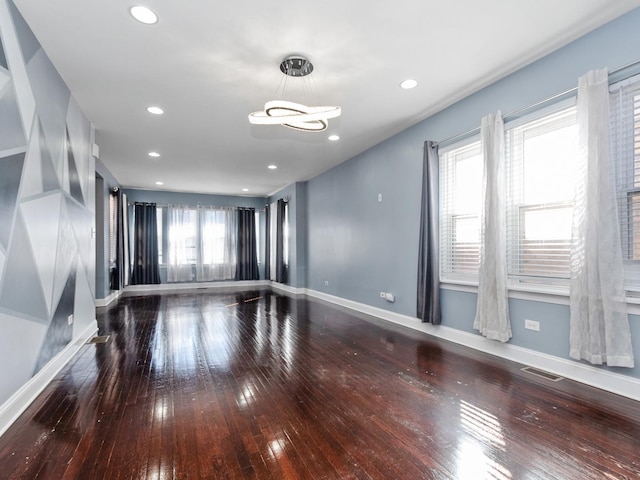 8018 S Luella Ave, Chicago, IL 60617 - unfurnished room with hardwood / wood-style floors, an inviting chandelier, baseboards, and visible vents