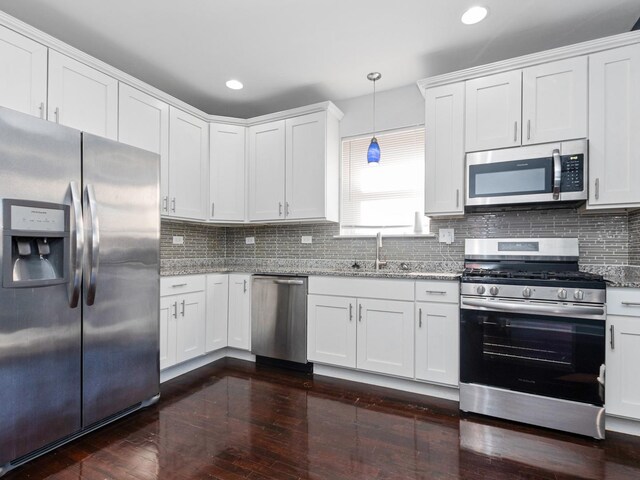 unfurnished bedroom featuring baseboards, wood-type flooring, visible vents, and ceiling fan