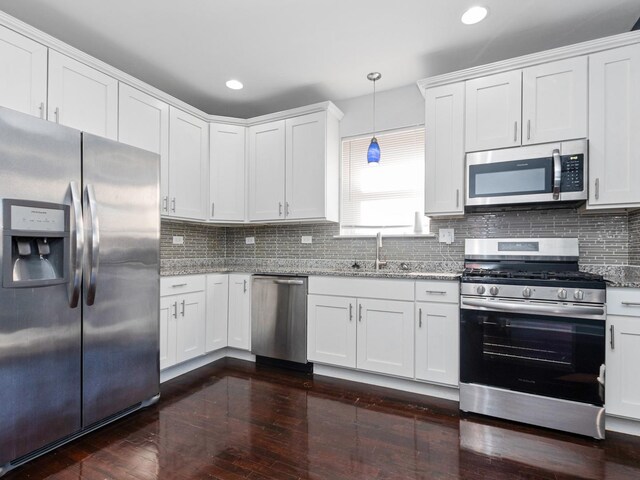 8018 S Luella Ave, Chicago, IL 60617 - kitchen featuring white cabinets, light stone counters, tasteful backsplash, and stainless steel appliances