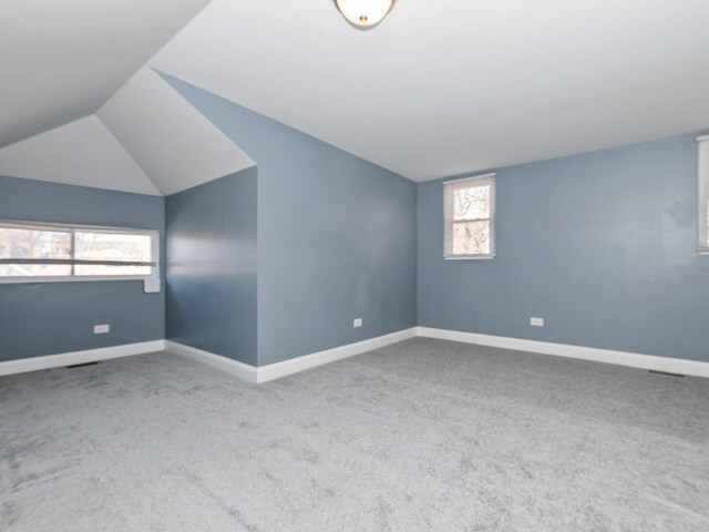 8018 S Luella Ave, Chicago, IL 60617 - carpeted empty room featuring baseboards and lofted ceiling