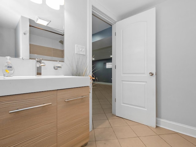 bathroom featuring tile patterned flooring, vanity, and baseboards