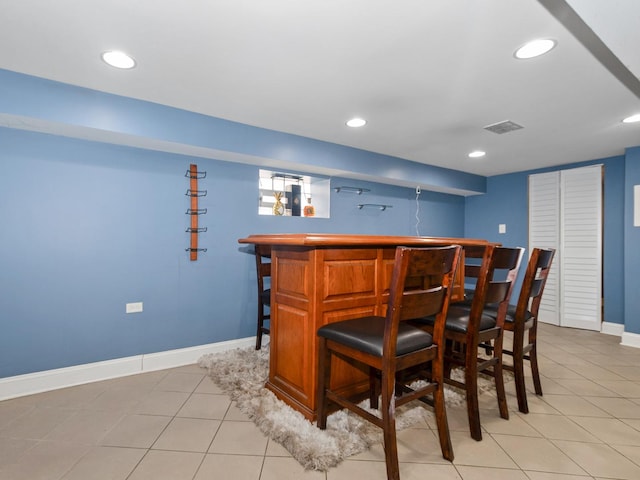 8018 S Luella Ave, Chicago, IL 60617 - bar featuring light tile patterned floors, recessed lighting, a bar, and baseboards